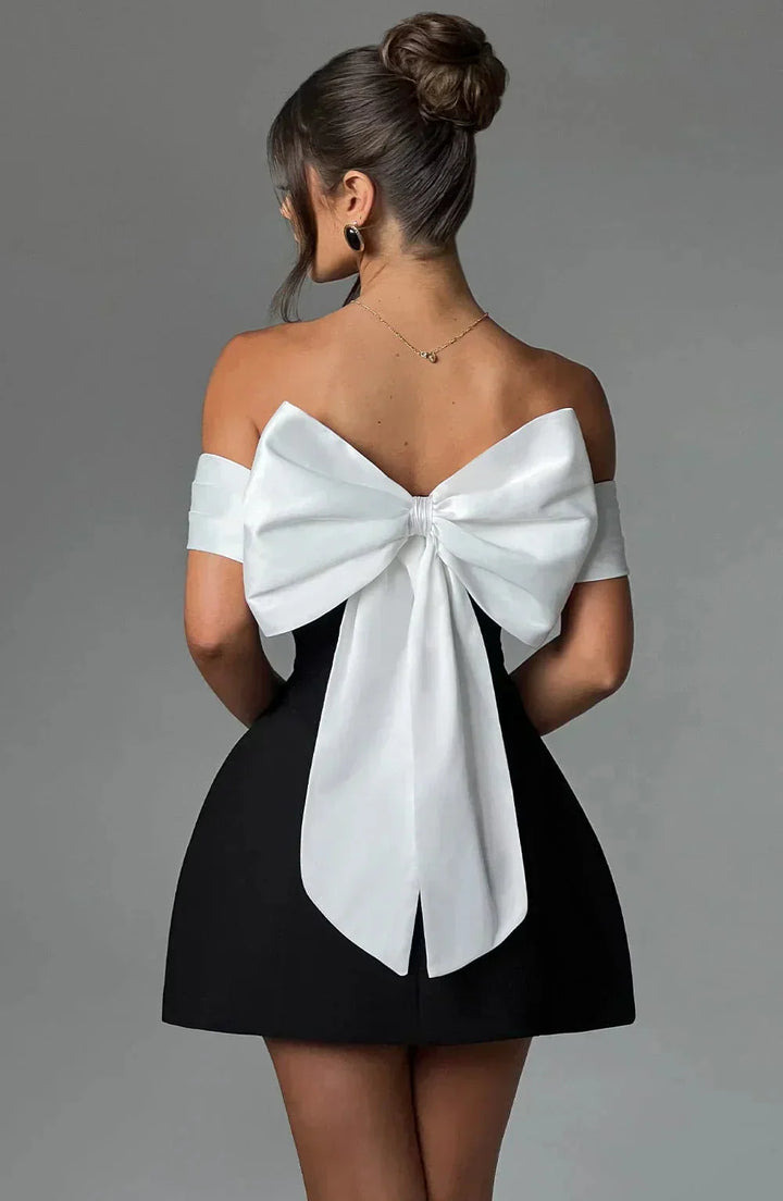 Off-shoulder mini dress in two-tone design with a flowing silhouette and elasticized neckline by Carmela.