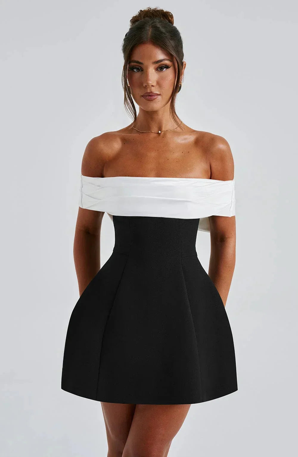 Off-shoulder mini dress in two-tone design, featuring a lightweight and breathable fabric perfect for summer outings.
