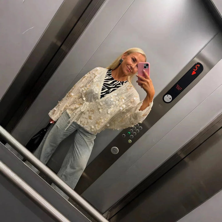 Ivory sequin v-neck blouse for women, featuring intricate sequin detailing on a soft, elegant fabric.