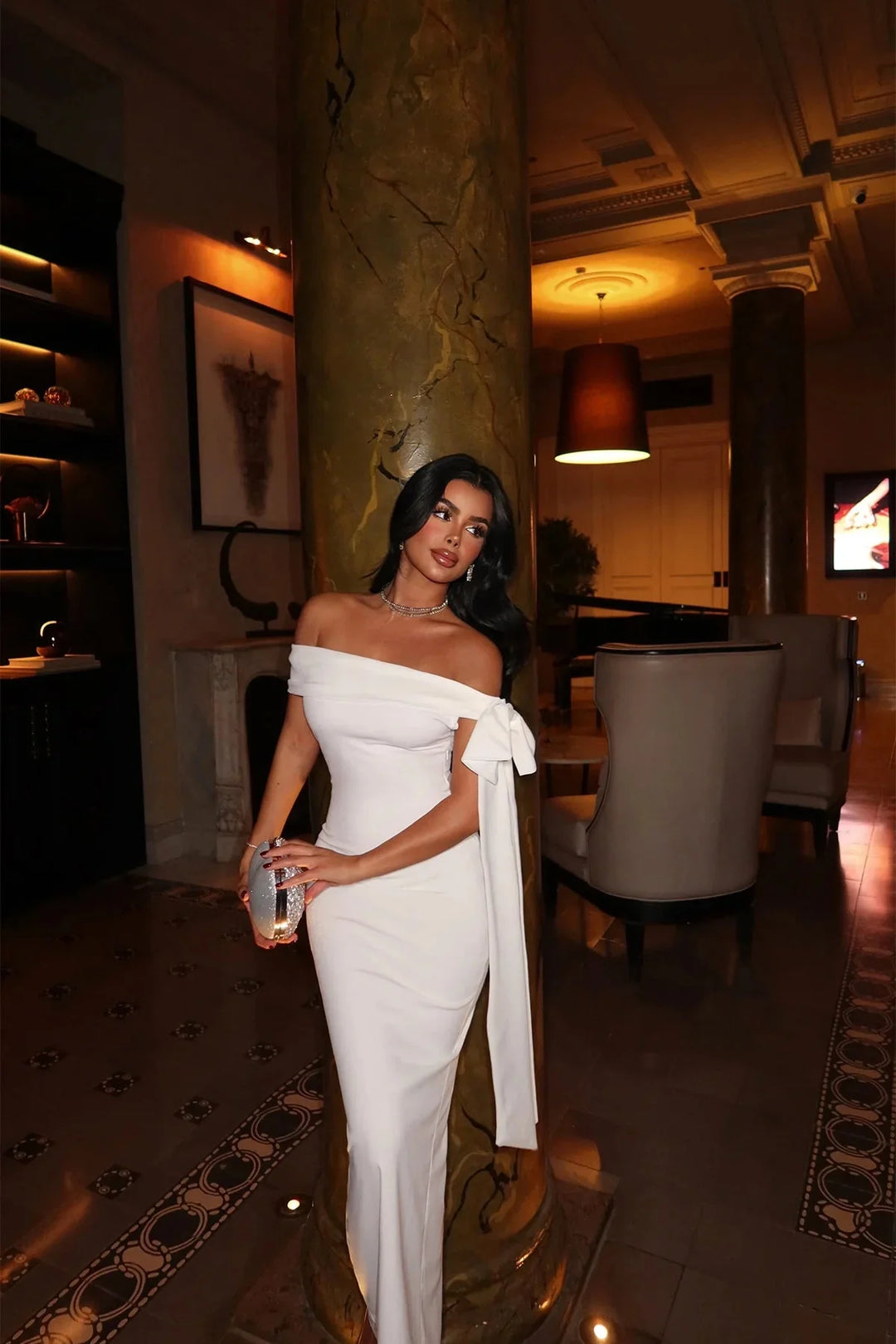 White maxi dress with a flattering fit, V-neckline, and flowy design. Ideal for any occasion.