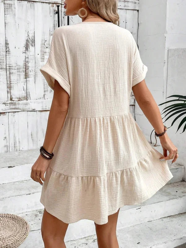 "Blue v-neck dress with cascading ruffled layers, perfect for a breezy summer day"