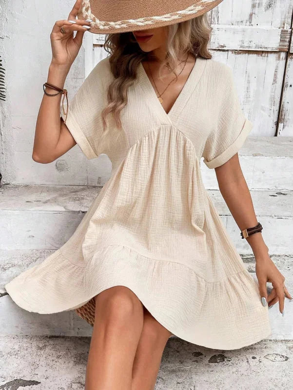 "Cattleya dress in flowing chiffon fabric with v-neck and cascading ruffles"