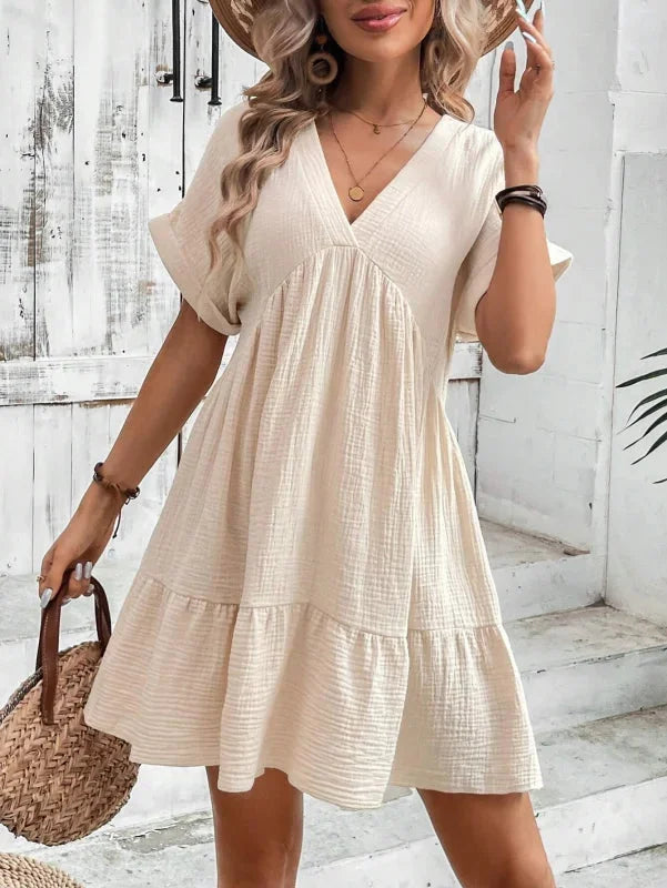 Khaki flowy v-neck dress with ruffled layers, perfect for a relaxed yet stylish look.