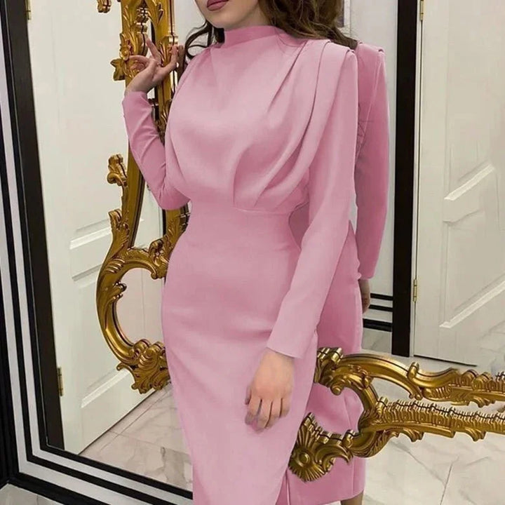 Pink high-neck maxi dress with dramatic sleeves, made of soft and flowy fabric. Perfect for a chic and sophisticated look.