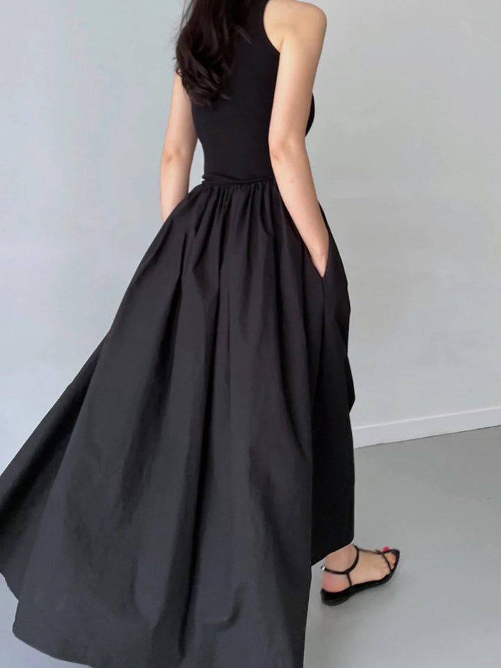 "Sleeveless jersey dress featuring a gathered waist design by Charlene, perfect for casual or formal occasions."