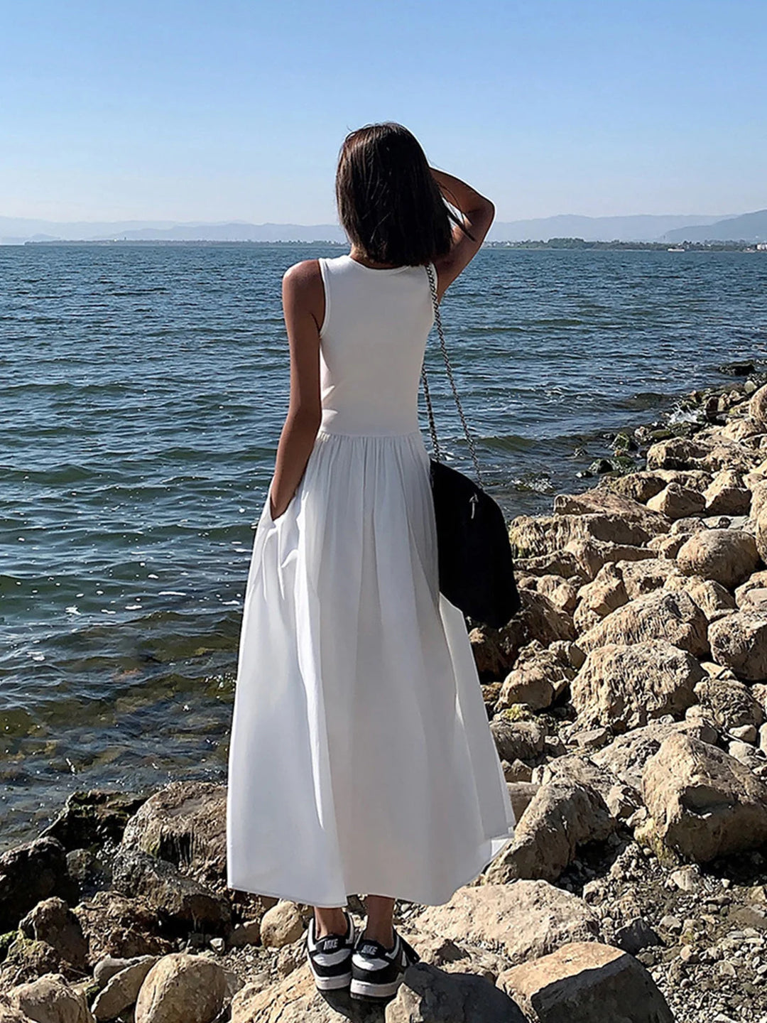 "Sleeveless jersey dress with a gathered waist, perfect for a casual day out or an evening event."
