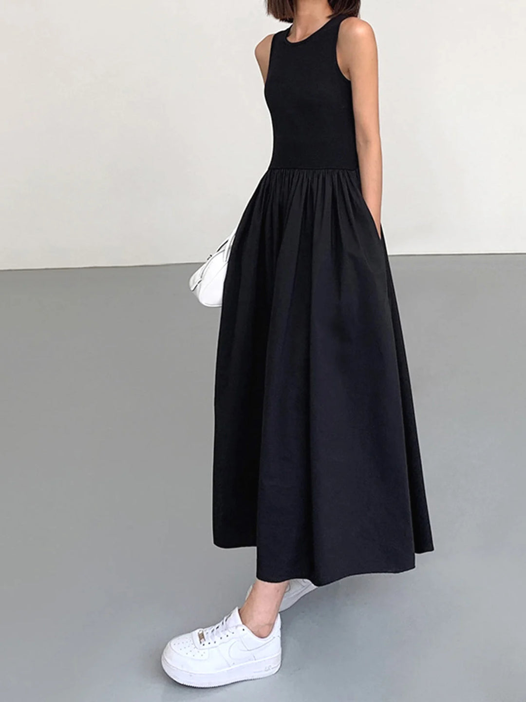 "Sleeveless jersey dress in Black with gathered waist, perfect for casual or formal occasions."