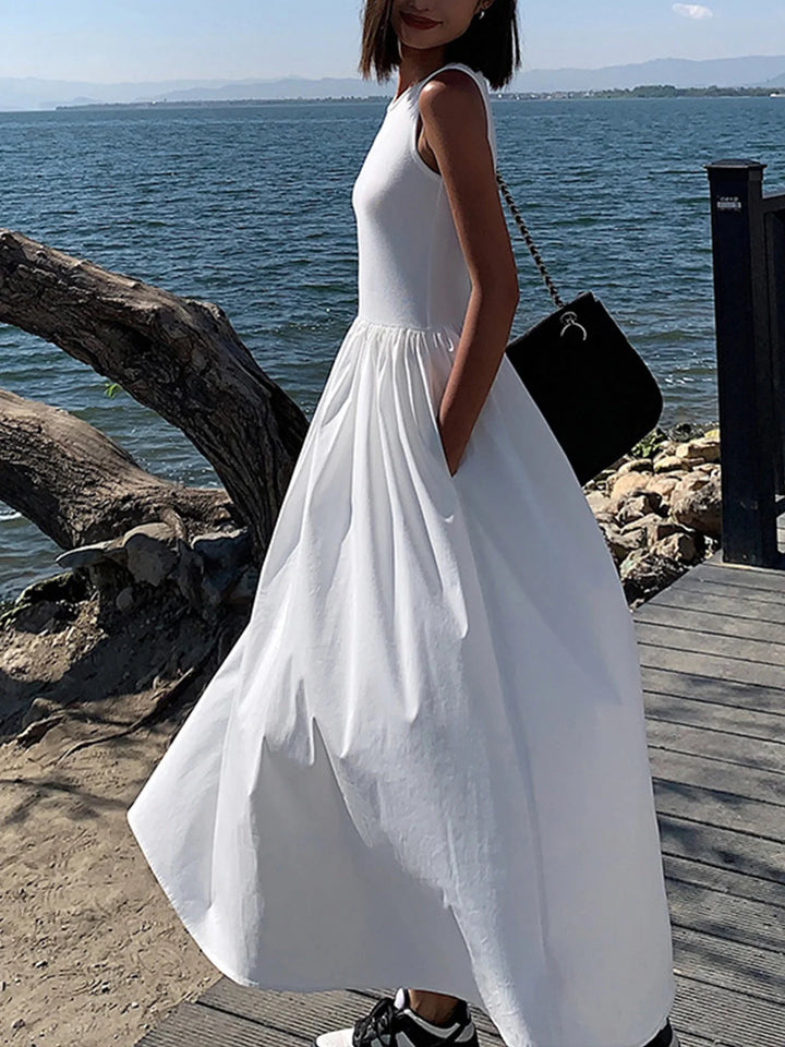 White sleeveless jersey dress with gathered waist detail, casual and comfortable for everyday wear.
