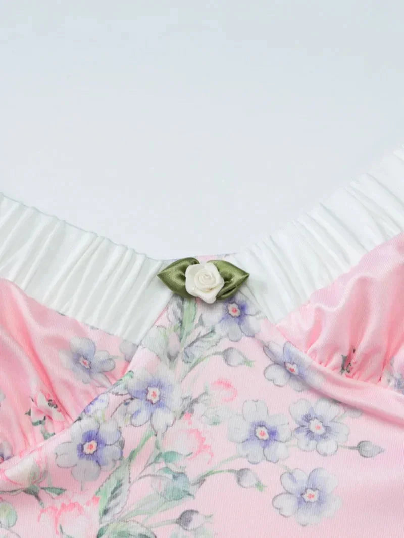 Pink floral maxi dress with ruffle details, ideal for summer. Features a relaxed fit and flowy silhouette with a charming…