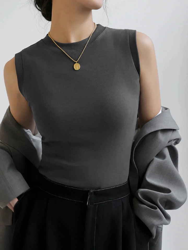 Sleeveless fitted top in soft cotton blend with structured silhouetted and ribbed texture.