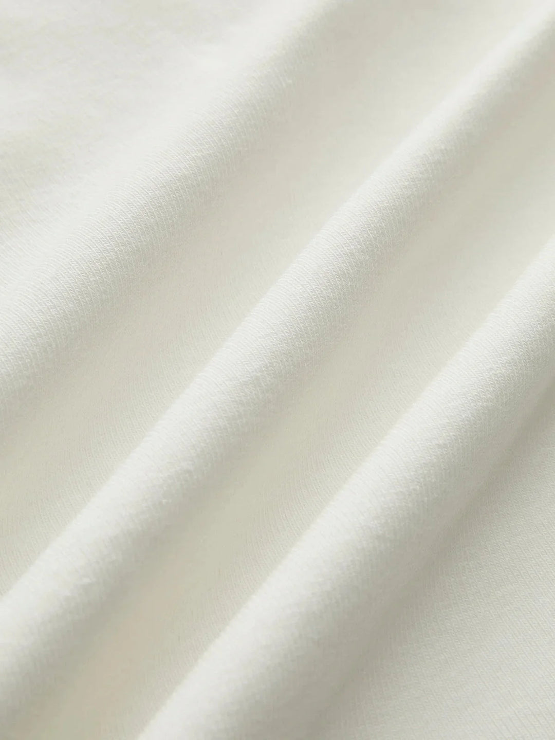 Sleeveless fitted top in soft cotton blend with V-neck and subtle ribbed texture in versatile heather gray.