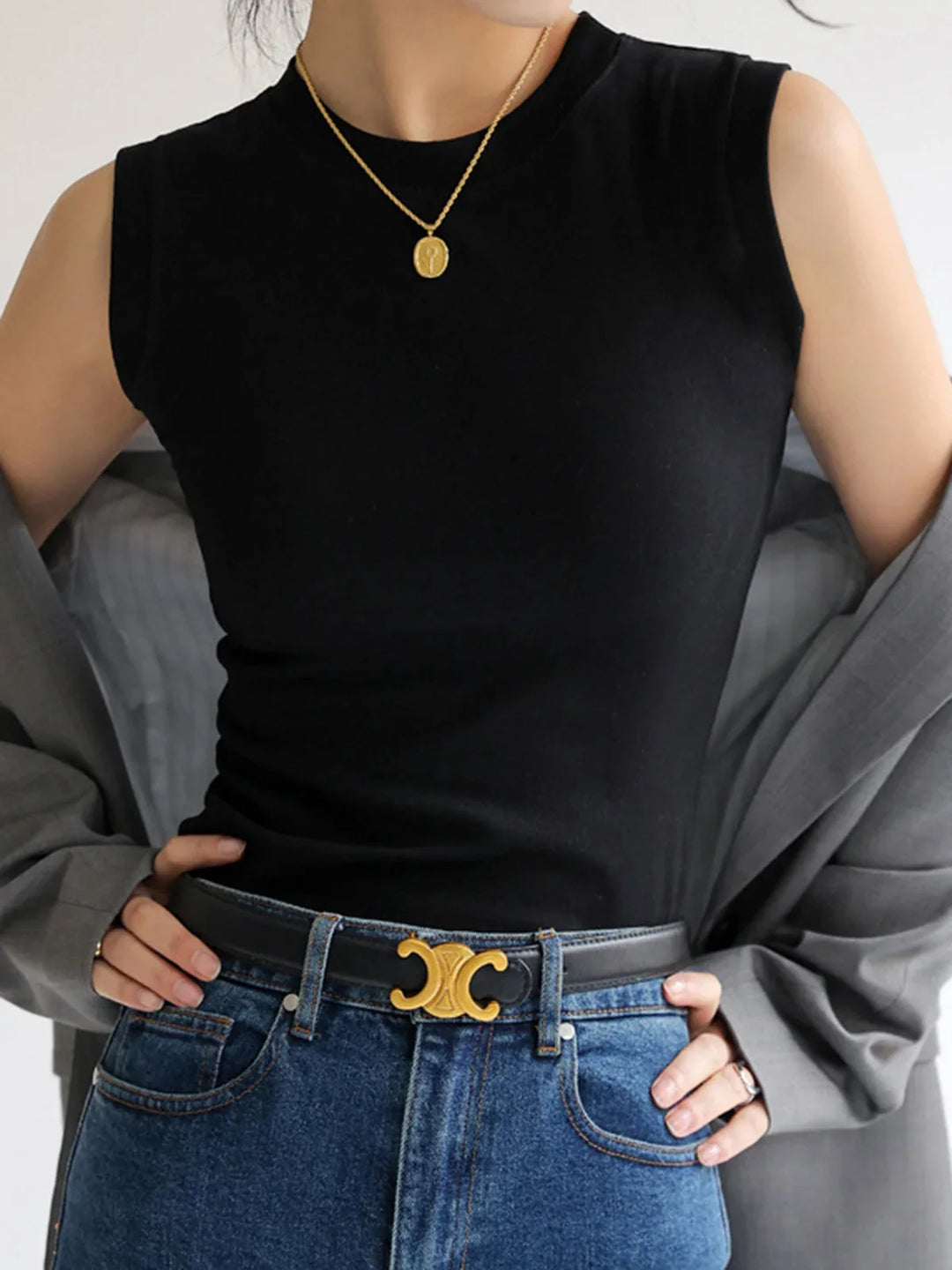 Black sleeveless fitted top with a flattering cut. Made from soft, stretchy fabric. Perfect for layering or wearing alone.