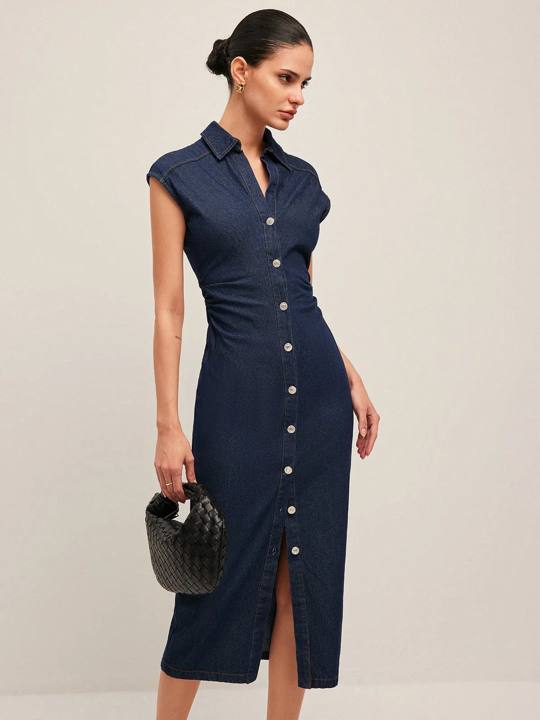 "Sleeveless dark blue denim midi dress with V-neck, perfect for casual wear."
