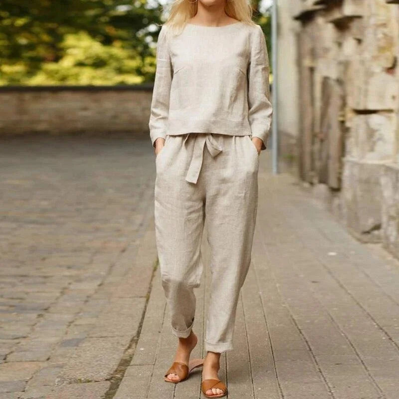 "Cindy - Women's breezy two-piece linen set in soft pastel blue color with cropped top and wide-leg pants, perfect for a…