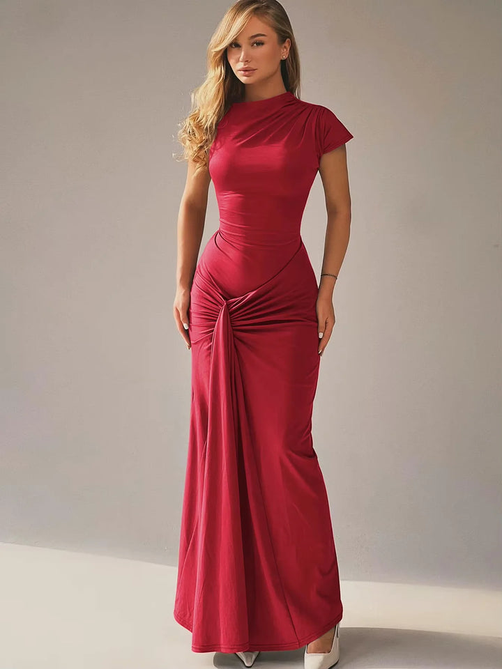 Black ruched maxi dress with capped sleeves, perfect for formal events. Made from stretchy, comfortable fabric.