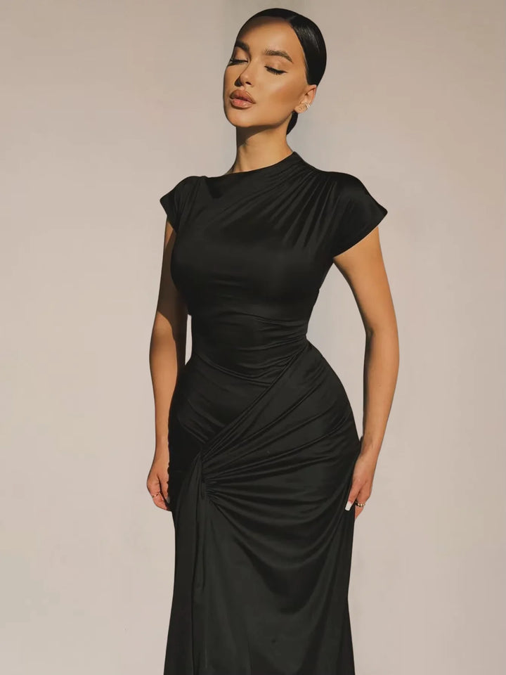 Ruched maxi dress with capped sleeves in a soft and flowy fabric, perfect for a casual yet stylish look.
