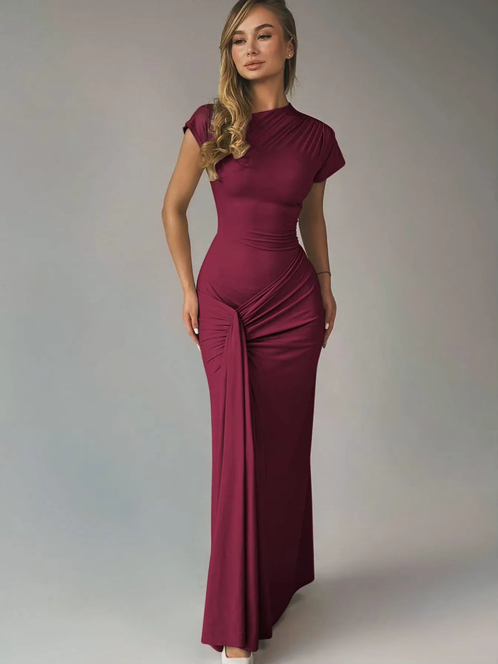 Navy blue ruched maxi dress with capped sleeves made from soft jersey fabric, ideal for casual or semi-formal events.