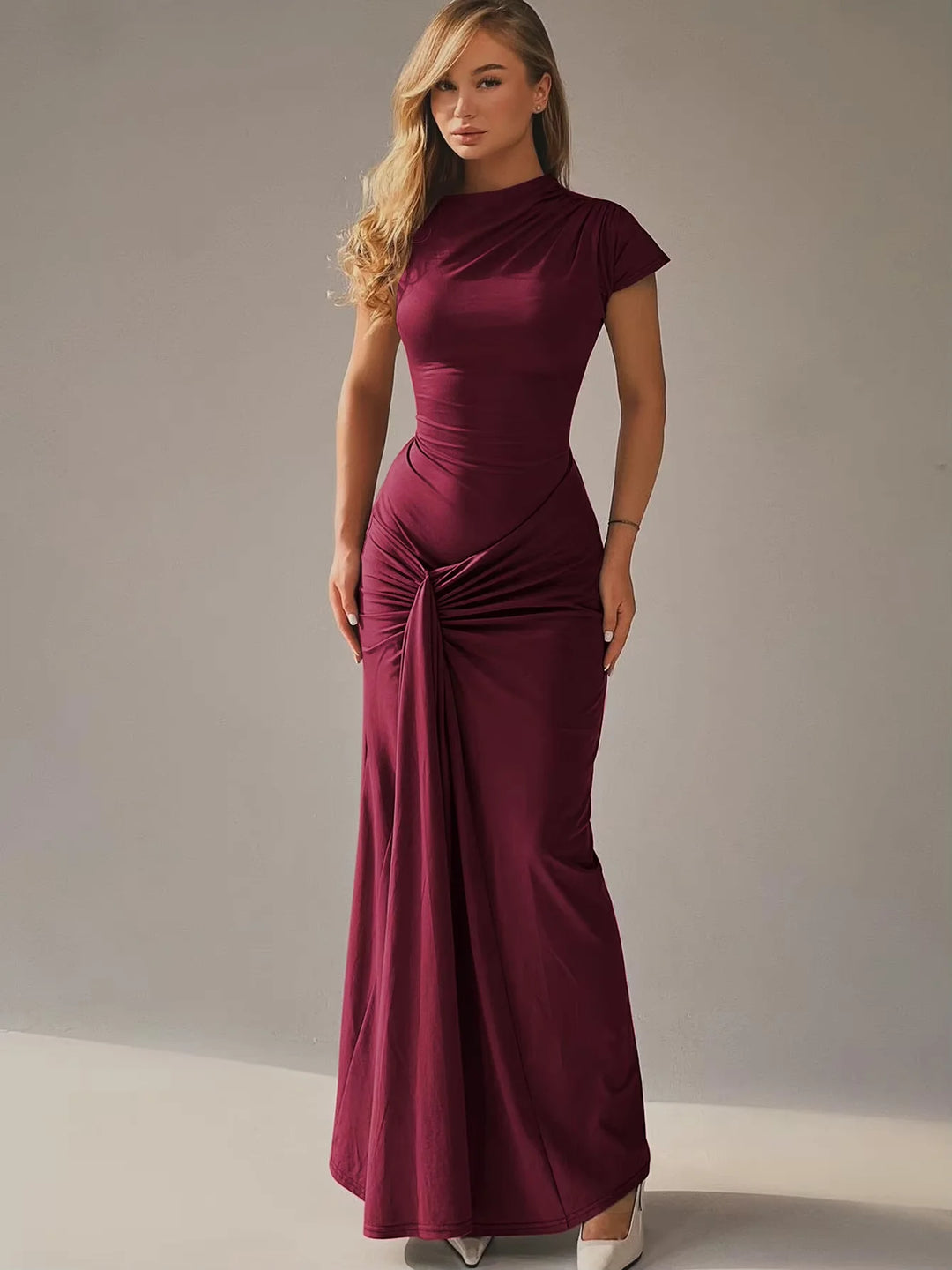 Burgundy maxi dress with ruched detailing, capped sleeves, and flowy silhouette.