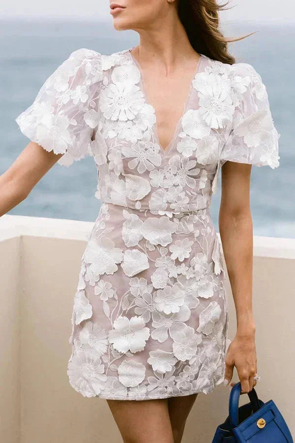 Sheer dress in white with puff sleeves, perfect for a summer day out.