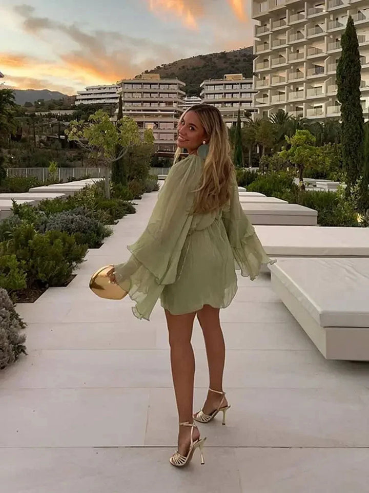 Sage dress with ethereal layers of ruffles, airy and elegant design for special occasions.