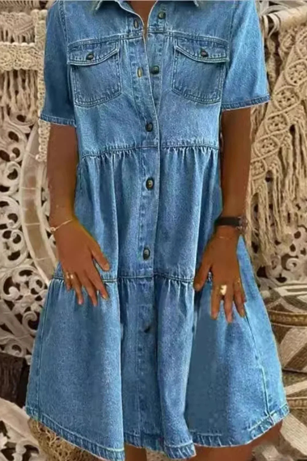 "Blue denim dress with short sleeves and functional pockets, perfect for casual and everyday wear."