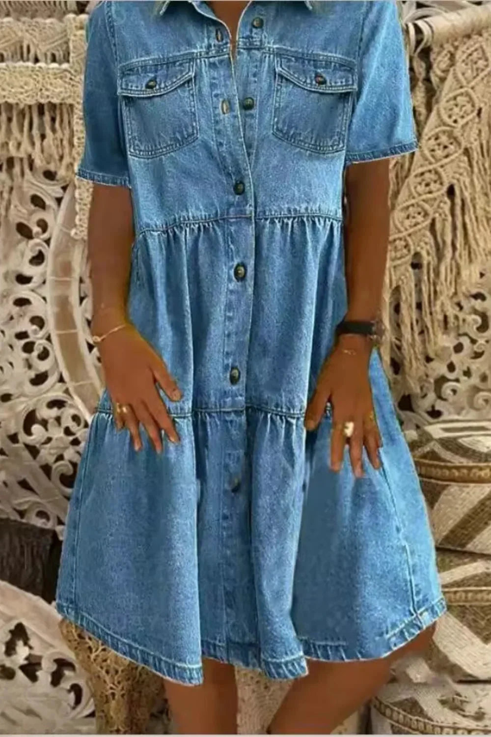 Dark blue denim dress with short sleeves and functional pockets. Casual and stylish design perfect for everyday wear.