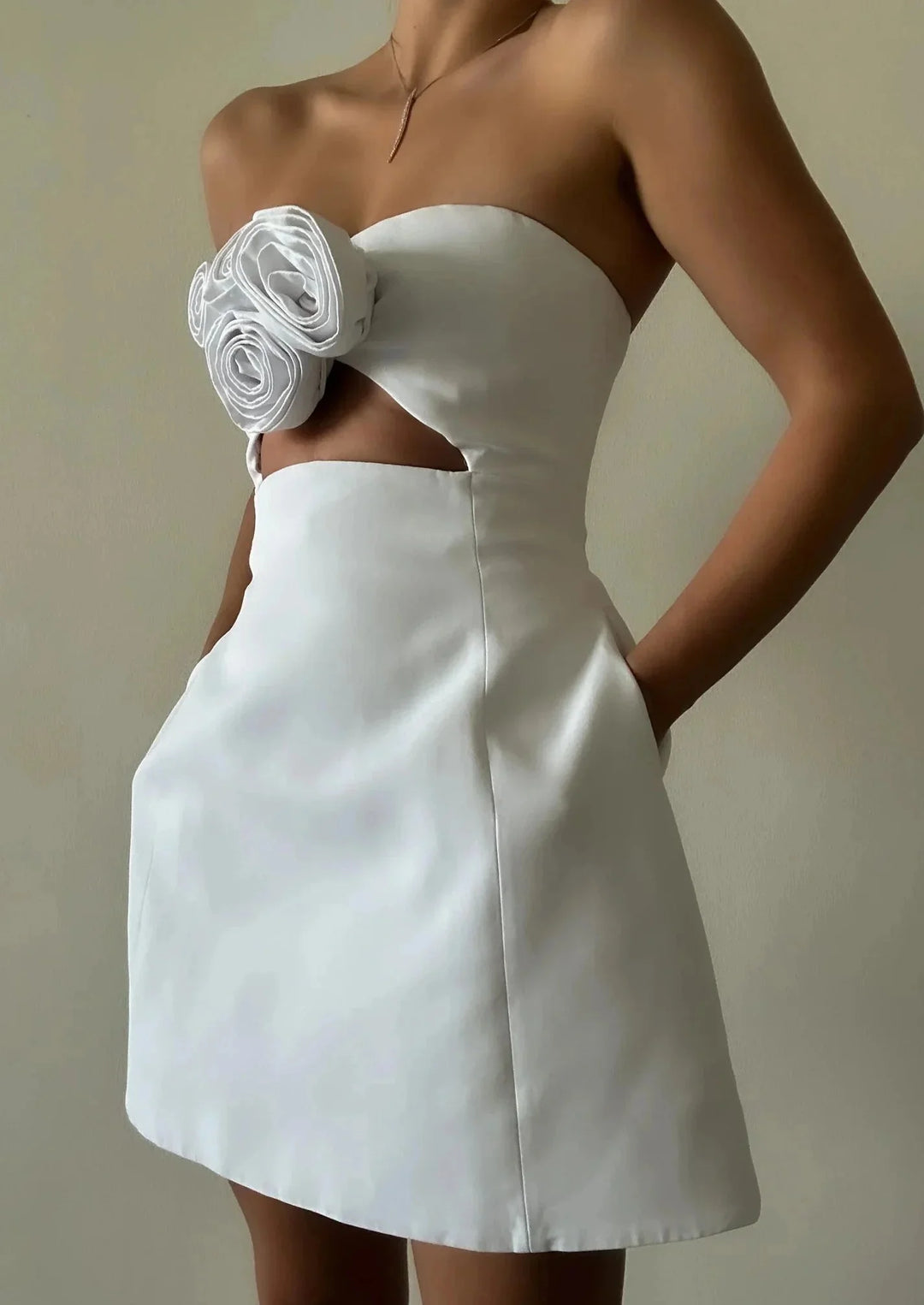 Strapless mini dress with floral accent, crafted in crystal material with intricate detailing for a chic and sophisticated…