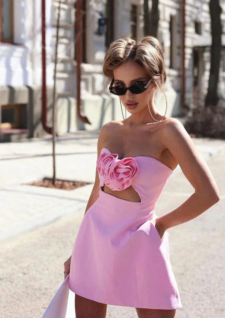 Strapless mini dress with floral accent in crystal material, perfect for special occasions or evenings out.