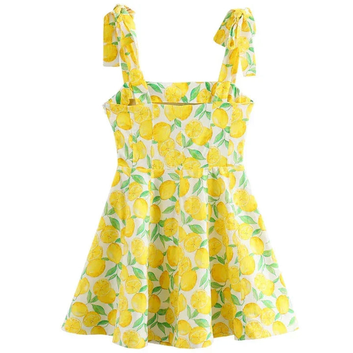 Sleeveless yellow mini dress featuring playful lemon print, perfect for a sunny day out, made of lightweight breathable…