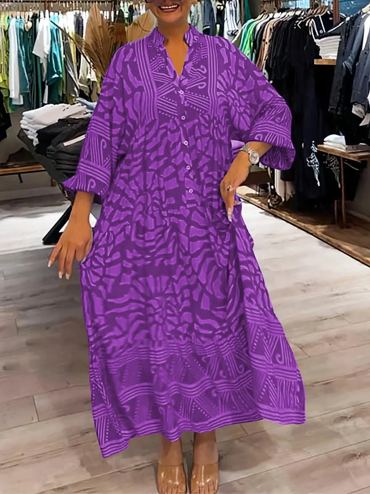 Purple flowy maxi dress with a unique printed design, flattering for all body types, ideal for casual or special occasions.