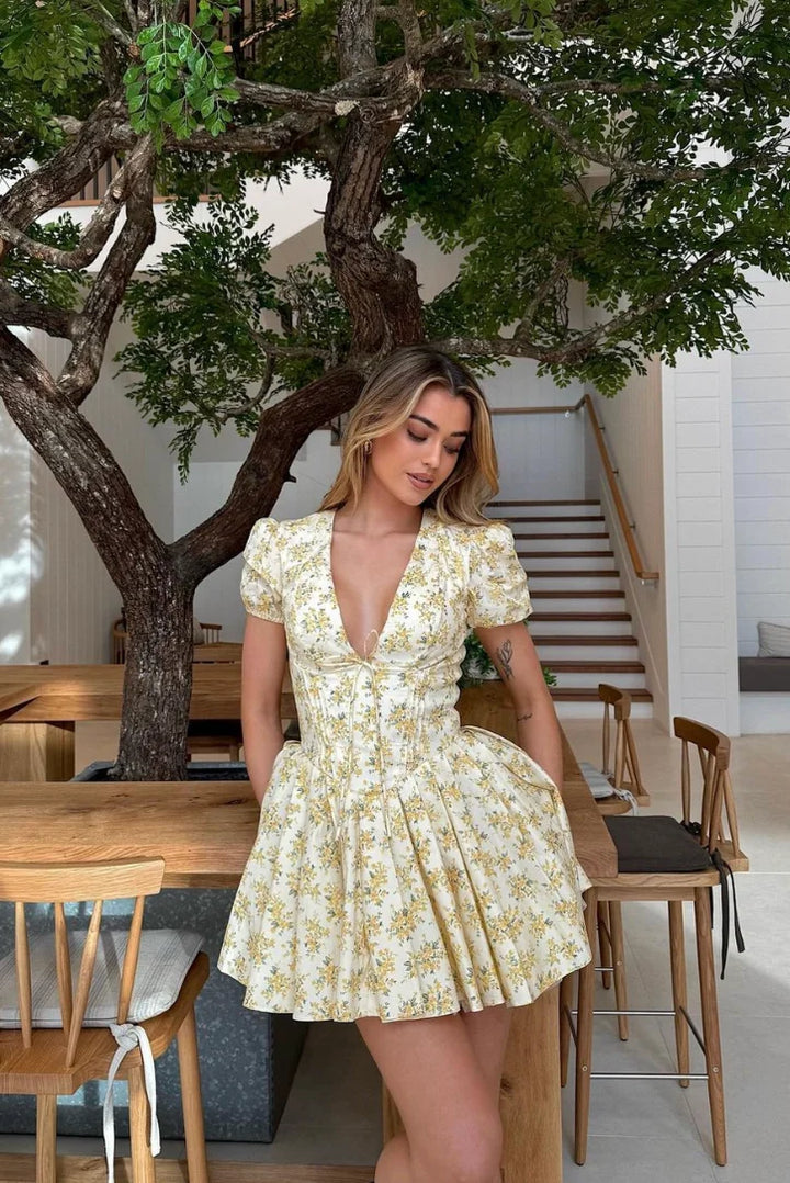 Yellow floral dress with back tie made of soft cotton blend. Features a charming floral print and tie detail at the back.