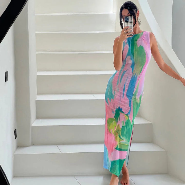 "Sleeveless tropical print maxi dress, showcasing a vibrant floral print on a lightweight flowing fabric for a summer-ready…