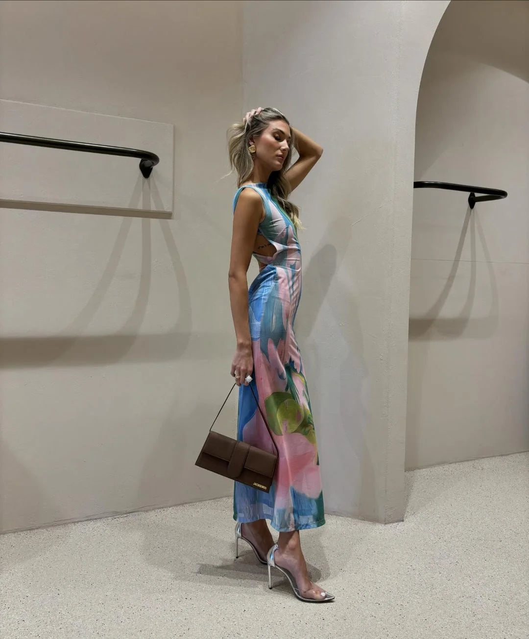 "Sleeveless tropical print maxi dress with vibrant leaf pattern, perfect for summer days out."