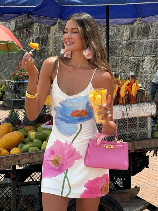 "White mini dress featuring a bold floral design, perfect for a casual and chic look. Made of soft and lightweight fabric."