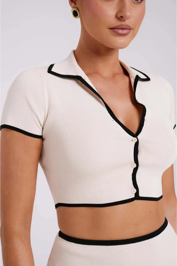 "Ribbed white mini set with black trim, featuring a flattering design and high-quality material."