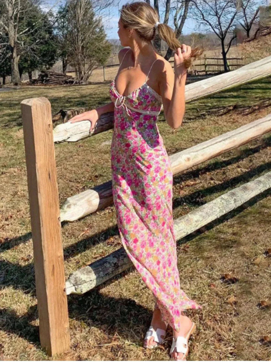 Pink floral sundress with lace accents, perfect for sunny days. Made of lightweight fabric with a delicate design.