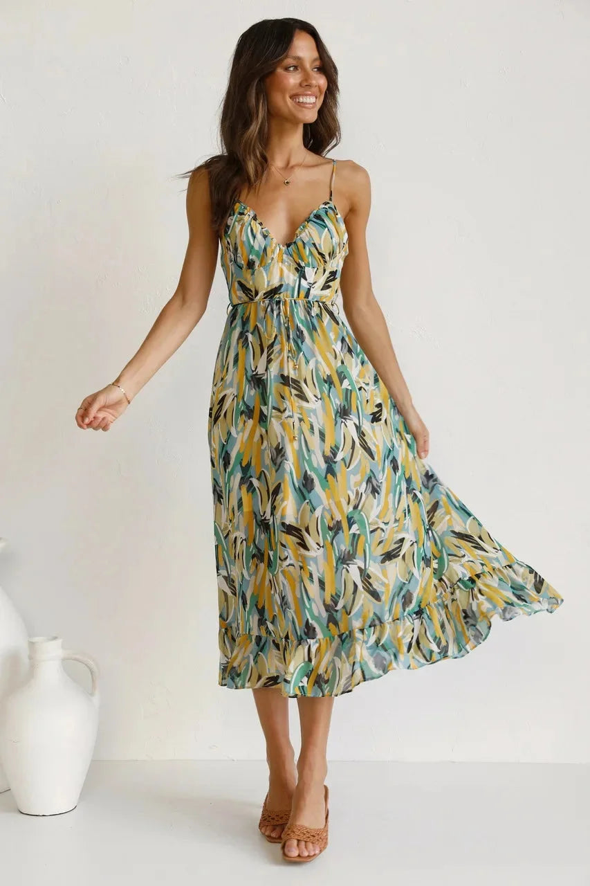 "Green flowy maxi dress with vibrant print, perfect for summer days. Made from lightweight and breathable material."