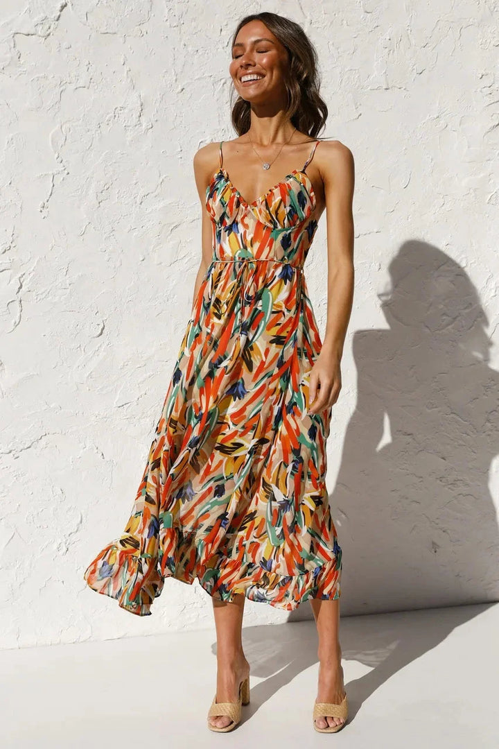"Flowy orange maxi dress with vibrant print, ideal for summer days. Soft and breathable fabric with a flattering silhouette."