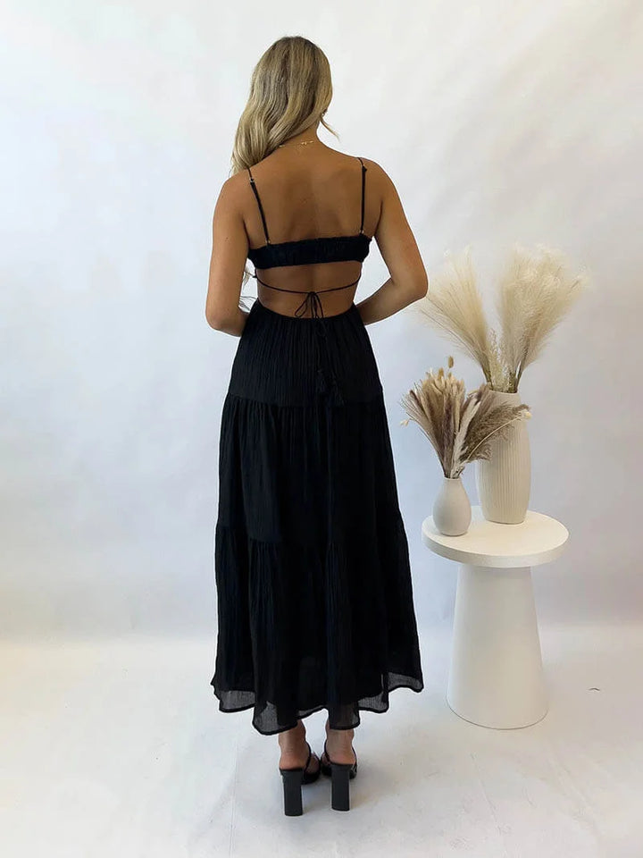 "Delila tiered maxi dress in light and flowing fabric with drawstring waist, perfect for effortless summer style."