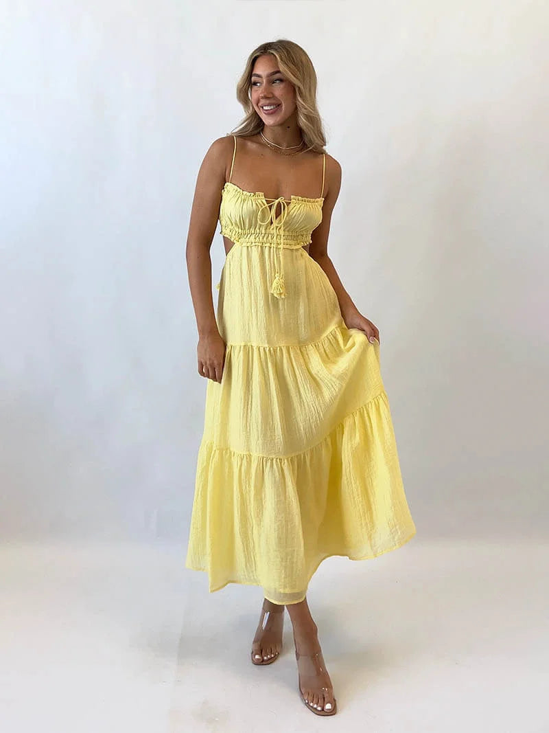Yellow tiered maxi dress with drawstring, made from lightweight cotton blend. Features a relaxed fit and bohemian style…
