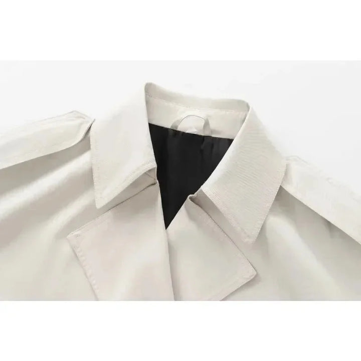 Ivory structured double-breasted jacket with a defined silhouette and button detailing crafted from premium quality fabric.