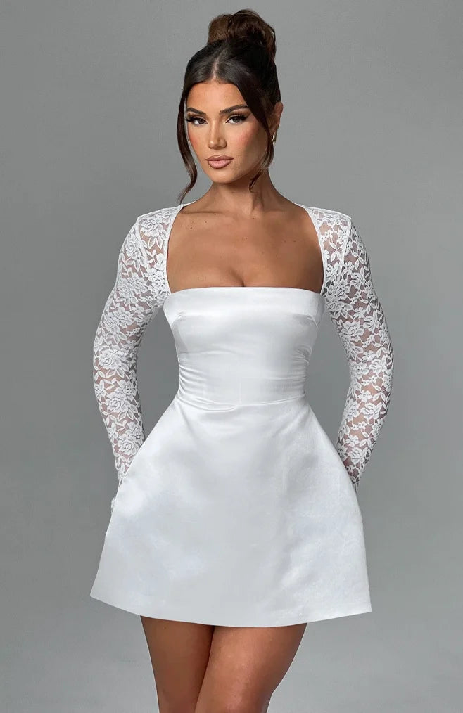 White blouse with intricate lace detailing in a flowy, lightweight fabric.