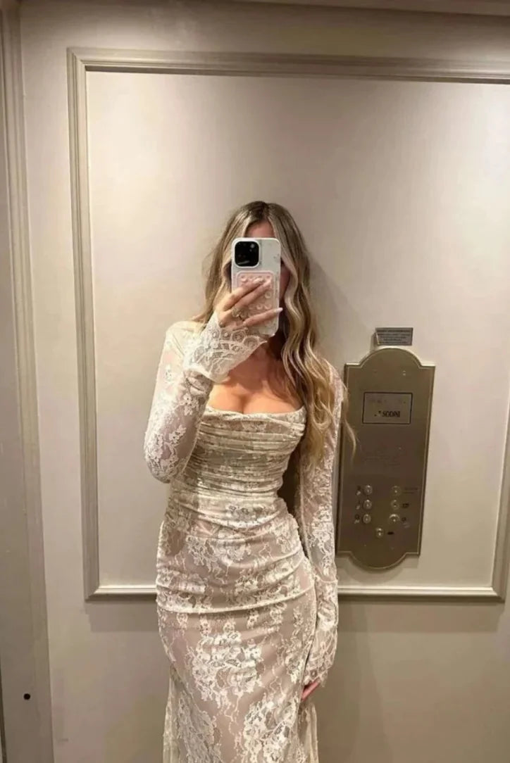 White lace dress with long sleeves, elegant and intricate design, perfect for a classy and chic look.