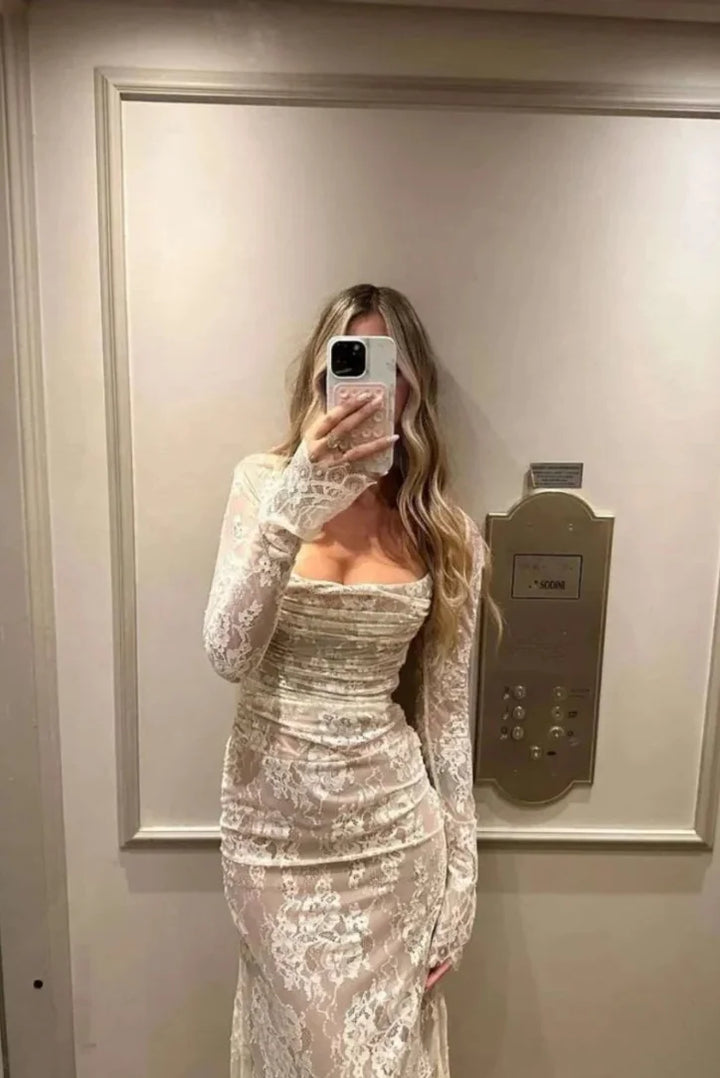 White lace dress with long sleeves, elegant and intricate design, perfect for a classy and chic look.