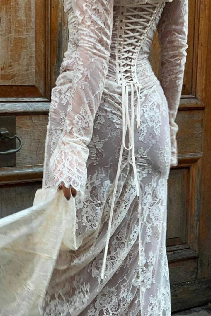 White lace dress with elegant long sleeves, perfect for any occasion.