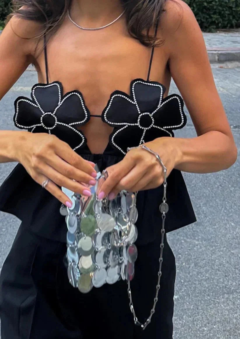 Black floral applique women's crop top with delicate detailing on neckline and sleeves. Made from soft and breathable fabric.