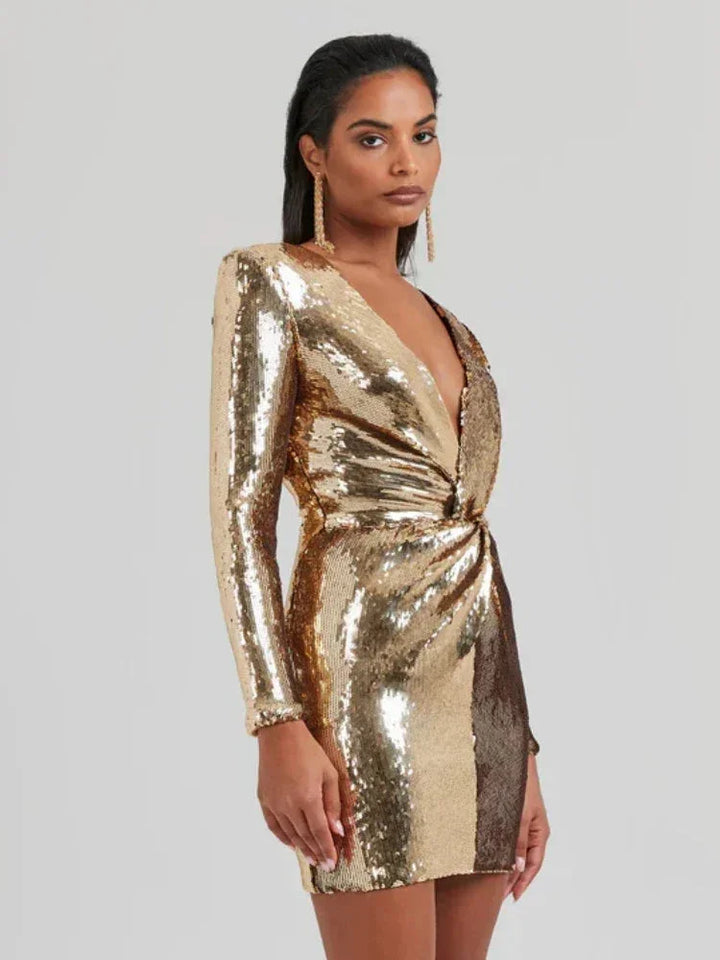 "Shimmering gold mini dress with sequins, long sleeves, and a chic design."