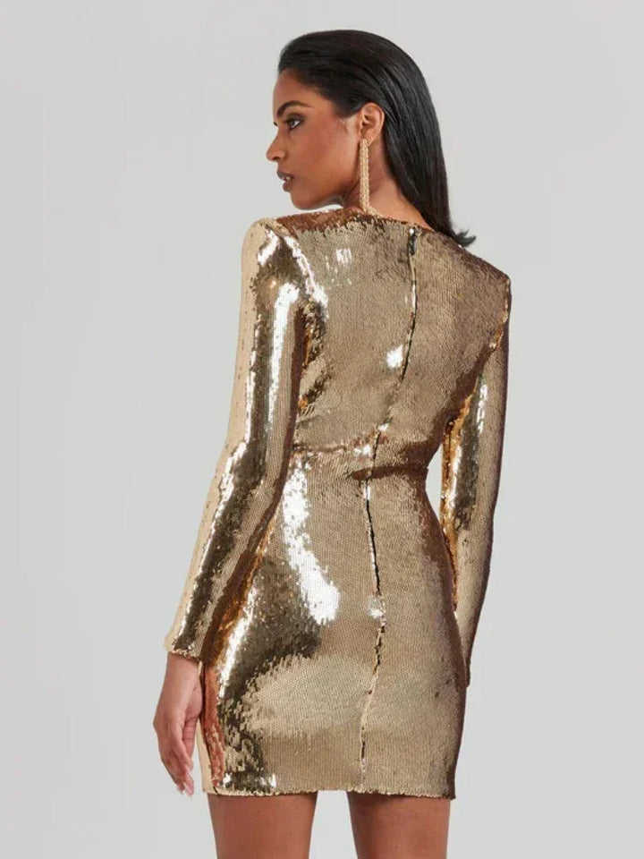 "Gold sequined mini dress with long sleeves, perfect for adding glamour to your outfit."