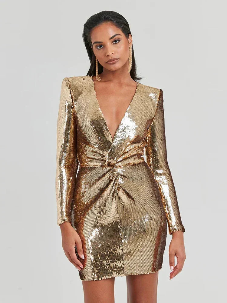 Shimmering gold mini dress with sequin embellishments and long sleeves for an elegant evening look.