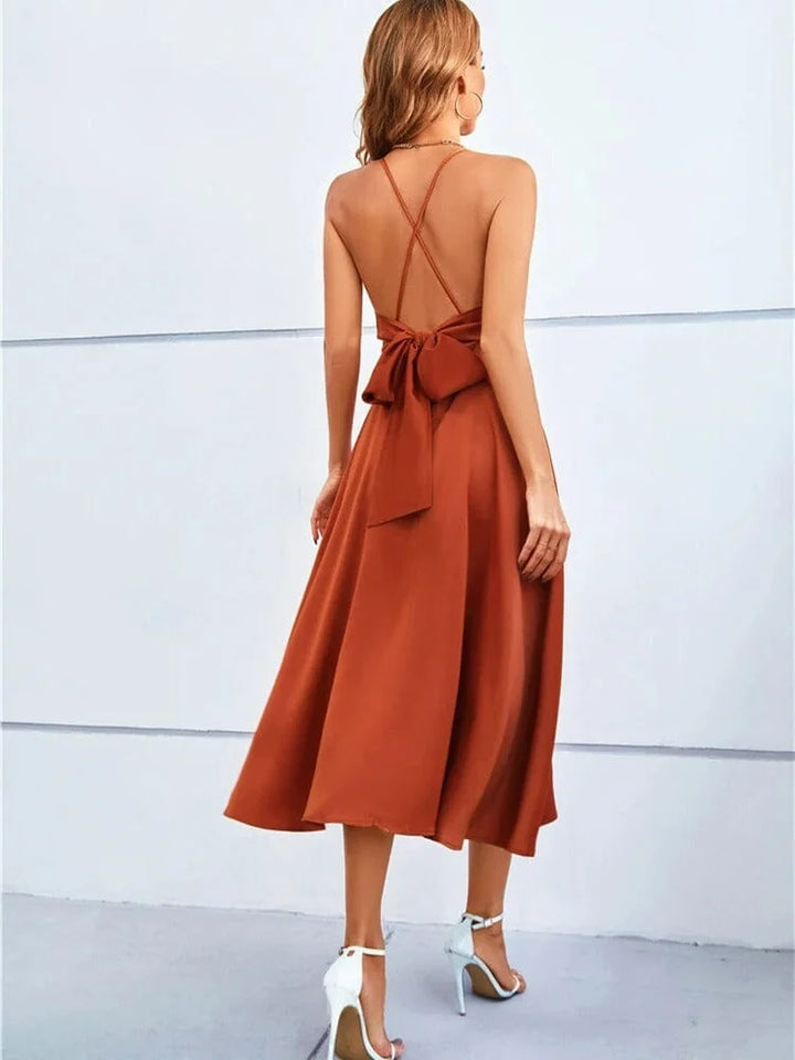 "Sleeveless silk midi dress with adjustable straps in a timeless design, perfect for any occasion."